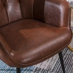 Fauteuil d'appoint en cuir marron foncé avec dossier capitonné et accoudoirs ailés
