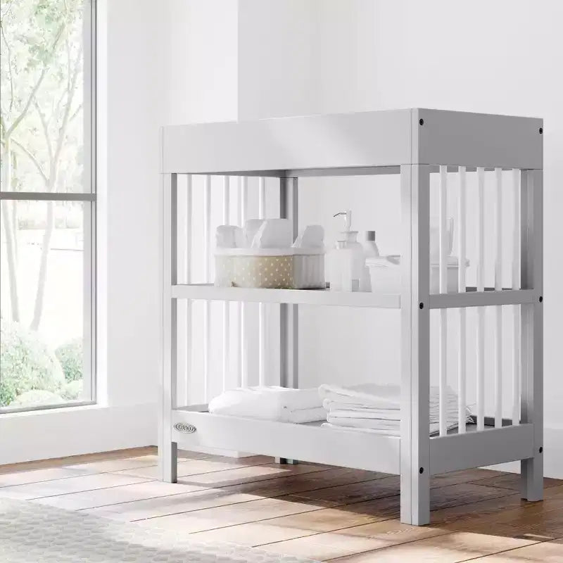 Table à langer Teddi de Graco avec matelas à langer résistant à l'eau